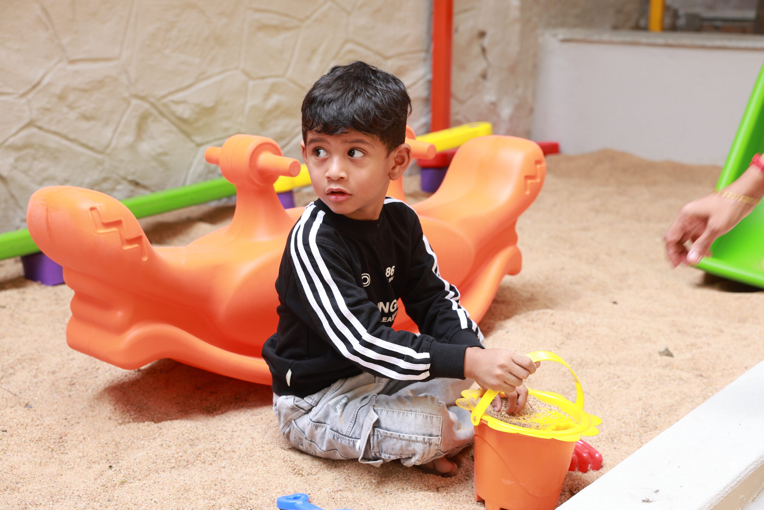A child exploring an activity at Kinder Kidsalaya